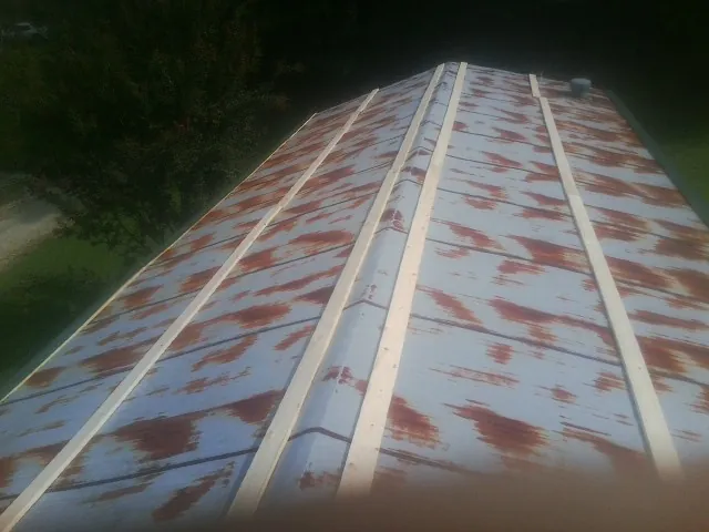 Rusted metal roof panels with new wood purlins before replacement — Storm Damage Roof Repair in Fairplay by Roofing Brothers